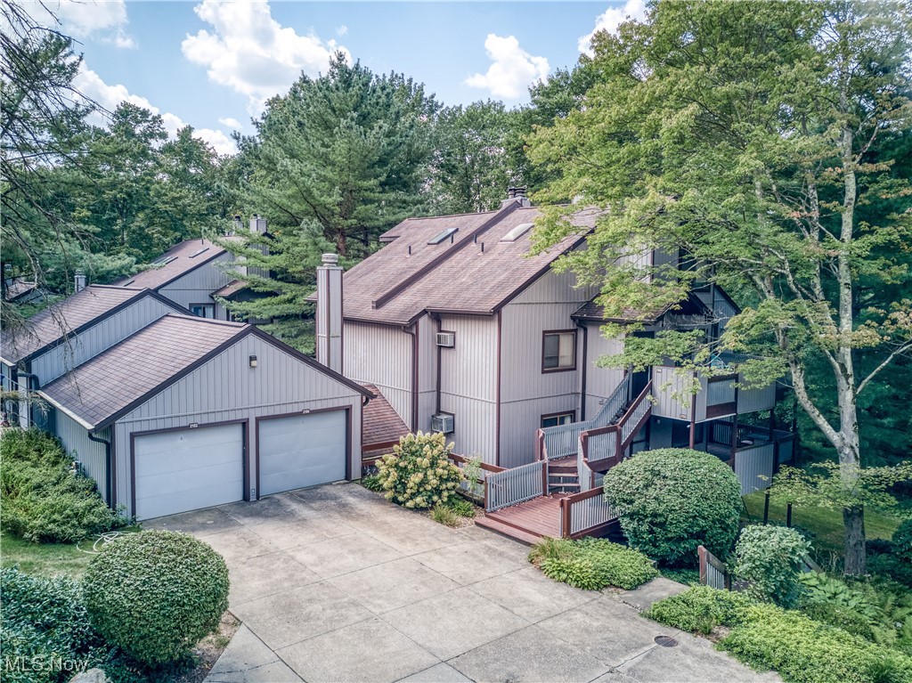 This spacious 2-bedroom, 2-full bath condo in Pine Mill Ridge offers the best of both worlds: peaceful, wooded living on the edge of Cuyahoga Valley National Park, yet just minutes from top shopping, dining, and entertainment. If you have been looking for a condo to make your own, this is the one! Starting with an inviting open floor plan, the kitchen, featuring a breakfast bar, seamlessly flows into the dining and living areas. Glass sliders lead from the living room to one of two private decks. A generous bedroom and main full bath complete the convenient first floor. The lower level expands your living space with a cozy family room featuring a wood-burning fireplace, a dedicated laundry room, and the primary en suite, boasting dual closets, a full bath, and a dedicated dressing area. Exterior features wooded views, one-car detached garage and community pool! Bring your style and vision and embrace a lifestyle of comfort, convenience, and natural beauty! HOA includes: gas, water, sewer, trash and heat in addition to the landscaping, property management, snow removal, recreation and reserves.