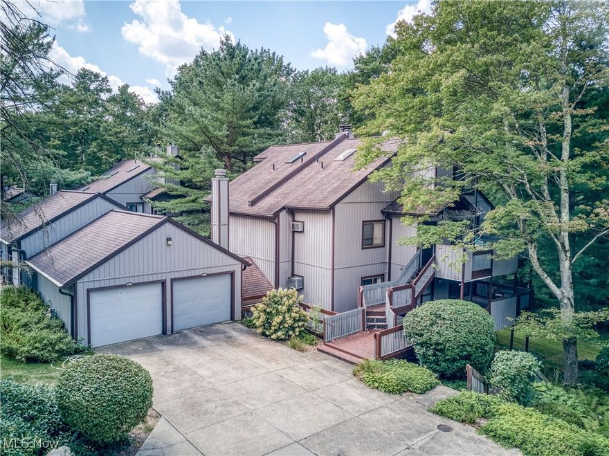 This spacious 2-bedroom, 2-full bath condo in Pine Mill Ridge offers the best of both worlds: peaceful, wooded living on the edge of Cuyahoga Valley National Park, yet just minutes from top shopping, dining, and entertainment. If you have been looking for a condo to make your own, this is the one!  Starting with an inviting open floor plan, the kitchen, featuring a breakfast bar, seamlessly flows into the dining and living areas. Glass sliders lead from the living room to one of two private decks. A generous bedroom and main full bath complete the convenient first floor. The lower level expands your living space with a cozy family room featuring a wood-burning fireplace, a dedicated laundry room, and the primary en suite, boasting dual closets, a full bath, and a dedicated dressing area. Exterior features wooded views, one-car detached garage and community pool! Bring your style and vision and embrace a lifestyle of comfort, convenience, and natural beauty! HOA includes: gas, water, sewer, trash and heat in addition to the landscaping, property management, snow removal, recreation and reserves.