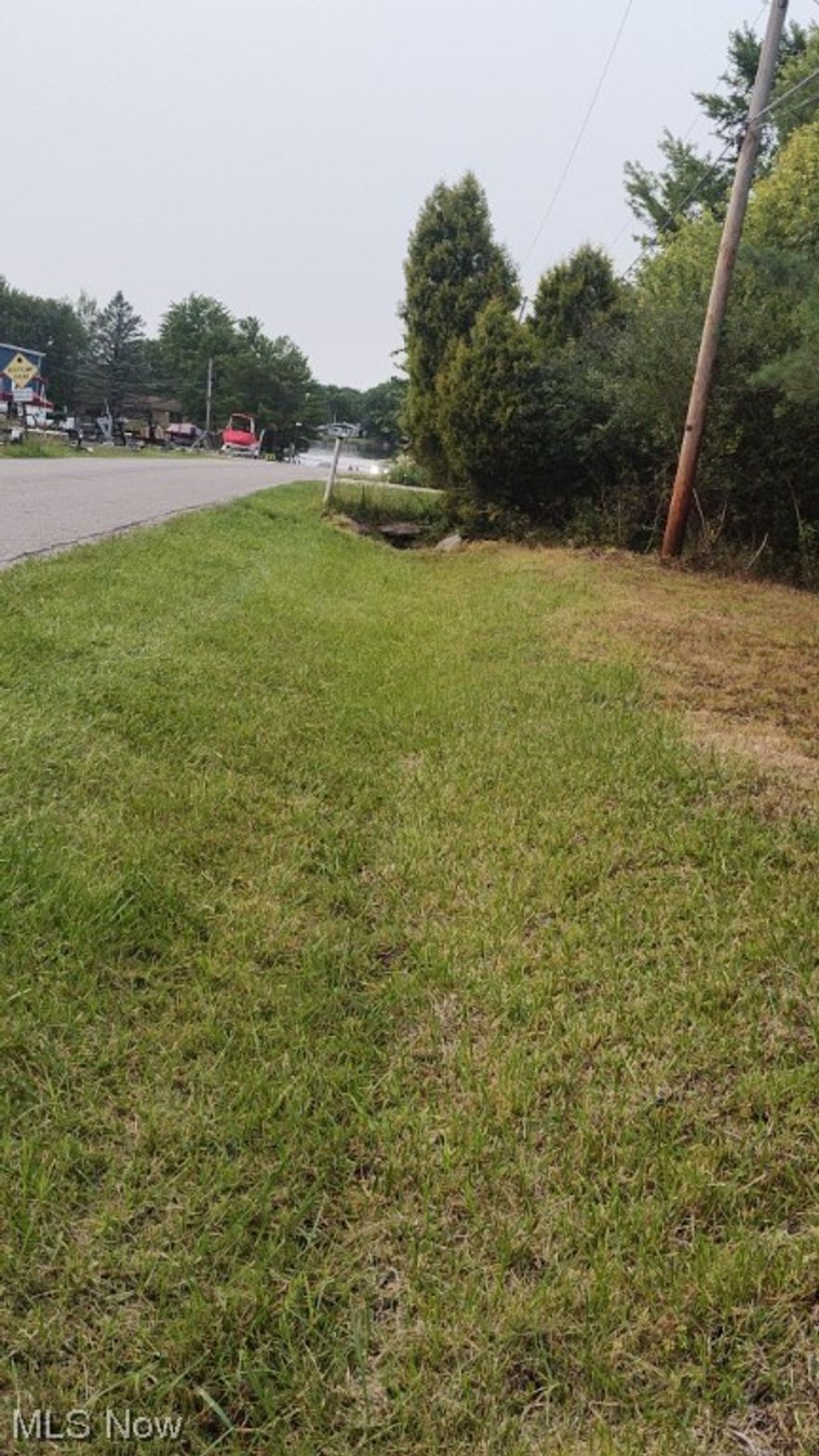 Location location, 2 lots across the street from the lake and Roaming Shores Marina . Wooded deep  lots that can be bought together or separate .. City water and sewer . Dock and marina are a walk across the street.