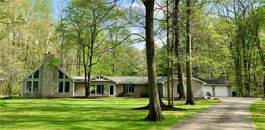 Refreshed Ranch waiting for you!  Sprawling 4 bedrooms, two living spaces, eat in kitchen, 4 bathrooms, laundry and mudroom ALL ON ONE FLOOR!  Situated on 5 private acres it is the perfect setting for entertaining and/or settling into your own silent corner of Lorain County.  The kitchen has walls of custom cabinetry for ample storage and an abundance of counter space. Your family can gather around the large kitchen island or sit down at the table to enjoy dinner in the eat-in kitchen area. For cozy nights at home, sit together in the large family room around the fireplace gazing out over your backyard through the sliding glass doors. If you prefer entertaining, set up in the great room with a full wet bar, full height windows letting in natural light and large space to
gather. The layout is perfect for hosting holidays or large groups of friends. An additional wet bar and finished space in
the basement adds to the living space as well as a bonus 300 square foot loft that can serve as a home office or kids’
playroom. The primary suite has large his/hers walk in closet space, large double vanity, jetted tub and shower. An
oversized two car garage provides room for two cars with plenty of room remaining. The additional garage can house a
third car, or additional storage. A large mudroom and laundry are located on the main floor and have nice built ins for
extra storage space. Close enough to be convenient, far enough to be alone. Set up a showing today!