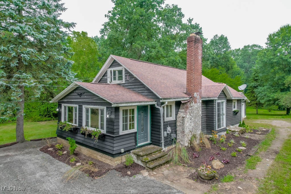Tucked away on over an acre in Barberton, this cape cod has so much to love inside and out! Updates include a newer roof, windows, high efficiency furnace and A/C, plus tankless hot water and a softener. Step inside to a welcoming foyer that opens to the living room with a wood burning fireplace and laminate flooring that continues into the dining area. The kitchen is full of character with rounded end cabinetry, a tile backsplash, and stainless appliances. Two main floor bedrooms enjoy private access to the covered back porch, including the primary with a brand new walk in closet. An updated full bath with a jetted tub and shower completes the main level. Upstairs, the attic with hardwood flooring is a bright and versatile space with plenty of potential for an additional bedroom. The full basement provides plenty of storage, a laundry area with washer and dryer included, a full bath, and room to finish for more living space. A breezeway offers the perfect spot to drop coats and shoes on your way in from the attached two car garage, complete with a workbench, electric, and a new door. Set back from the road and surrounded by mature trees, the property offers a peaceful setting with a fire pit ready for evenings with family and friends. Don’t miss your chance to see everything this well cared for home has to offer, call today!