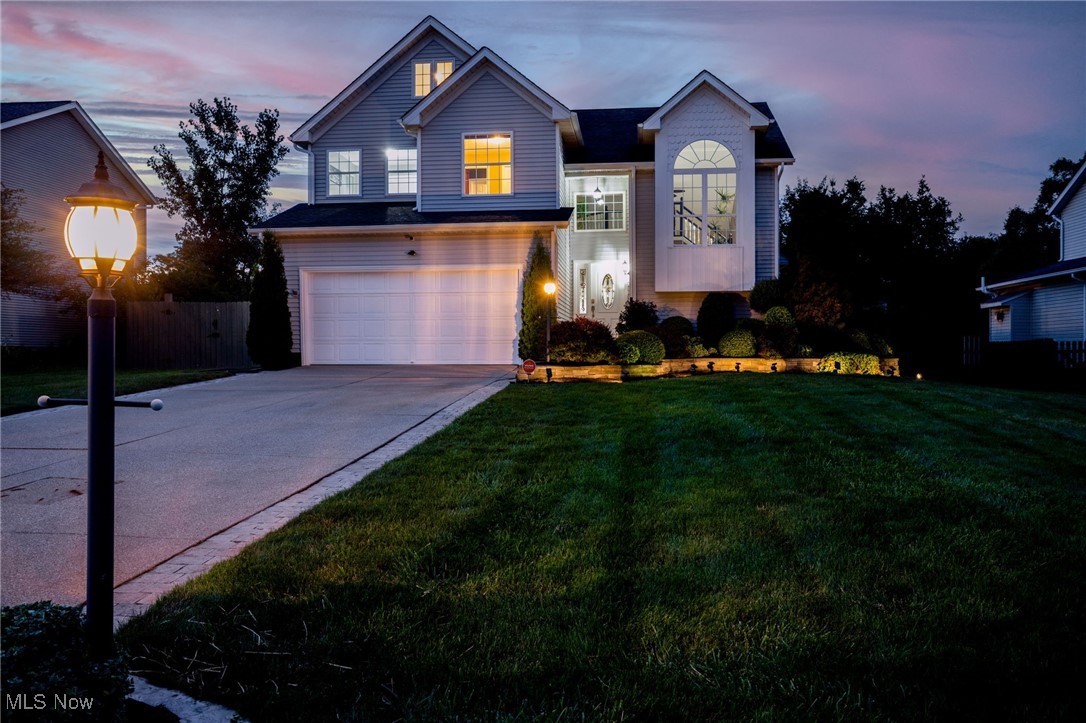 From the moment you arrive, the curb appeal is undeniable—professional landscaping and a welcoming front porch with paver stone-landscaped beds, set the tone for this fully renovated masterpiece. Step inside to the breathtaking great room, where soaring 20-foot ceilings and dramatic two-story windows flood the space with natural light. A stunning gas fireplace anchors the room, while an open catwalk hallway above adds architectural charm. At the rear of the home, the kitchen boasts brand-new vinyl flooring, a stylish tile backsplash, stainless steel Samsung appliances, and an inviting eat-in kitchen area—perfect for casual dining. The first-floor owner’s suite offers high ceilings and a spa-like ensuite with both a soaking tub and a separate shower. A convenient first-floor laundry sits just off the oversized 2.5-car garage, and an additional half bath completes the main level. Upstairs, you’ll find a second owner’s suite with its own full bath, unique loft area, plus two more bedrooms and another full bathroom. The lower level is an entertainer’s dream—a fully equipped theater room with 50-foot high-speed 8K fiber optic cable, noise-reduction insulation, built-in speakers/subwoofer, and a kitchen area featuring over 60 sq. ft. of granite counters, an Insignia 48-beverage cooler, Magic Chef refrigerator, New Air wine cooler, and 16 recessed dimmable lights. There’s also a dedicated office, and utility room. A full camera and alert security system with 360° outdoor coverage and indoor window sensors. Every detail has been thoughtfully addressed—new lifetime waterproof flooring, fully waterproofed and insulated exterior concrete walls with vapor barrier panel. The rear yard is made for entertaining with a spacious deck, stamped paver patio, and full privacy fencing. A 1 year home warranty is included. This home blends impeccable design, top-to-bottom renovations, and high-end upgrades to create a truly move-in ready showpiece in Medina Township.