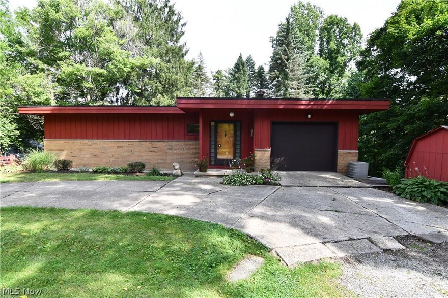 Unique ranch at 46 Winthrop Drive in Coventry Twp., close to Portage Lakes! The main floor offers 2 bedrooms, one with a wood burning fireplace. A huge living room with a second fireplace is located in the walk-out lower level, and features a wall of windows looking out to the private, wooded back yard. The tidy kitchen, also located on the lower level, has great views of the back yard. There is a combined utility/laundry/full bathroom, on the lower level. Newer carpet through out!