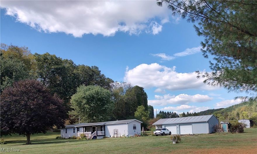 Beautiful views from this home in the back from the deck and the front porch! Come and relax. One floor living with spacious living room open kitchen and dining room. Kitchen was remodeled in September 2014 and a walk-in shower in was installed in the primary in suite. Main floor laundry. Primary bedroom with its own full bath. The opposite end of the home is 2 bedrooms and full bath. 3 Car Detached garage and a 10x20 sun room that is attached! Electric dog containment system . Located 8 miles NE of Newark just off of ST RT 79. Property is deemed Real Estate and is financeable.