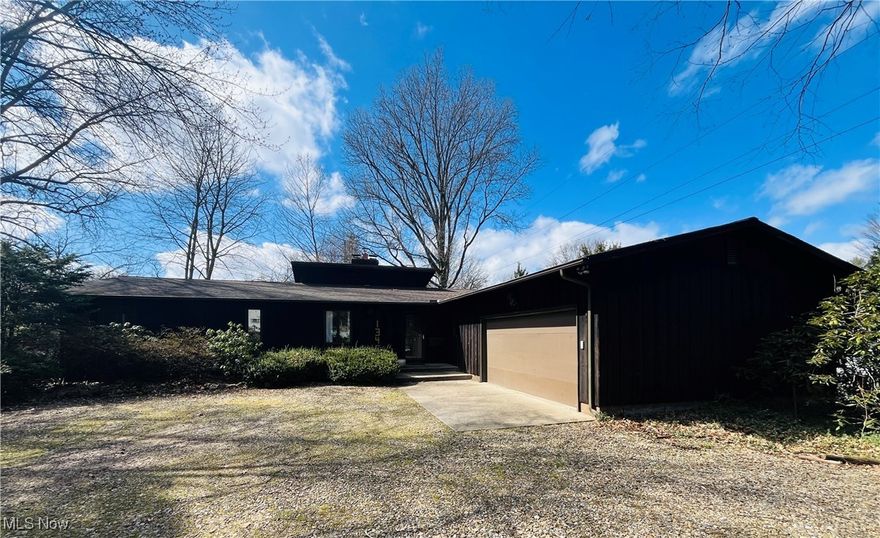 This is a rare opportunity to own an amazing ranch in the heart of Kent, with an additional living suite in the lower level with its own private entry! Situated in close proximity to Kent State and downtown, this rustic home is nestled in a mature tree setting with all of the modern-day conveniences and the perfect mix of Kent charm. You are greeted by a slate floor entryway and notice right away the abundance of natural light flowing in from every angle. The sunken living room has an entire wall of windows, with a vaulted wood plank ceiling, custom bookcase wall and is centered by a gorgeous fireplace. The chef's kitchen is completely updated with quartz countertops, updated hardware, double oven and tile floor. The kitchen flows perfectly into an eat-in area and then leads to the formal dining room. The dining space looks over the massive back deck and gives easy entry with a glass slider. There is a charming office space off of the main entryway that can also be used as a guest bedroom or large mudroom. Down the hall are three large bedrooms, including the spacious primary suite- which has a large walk-in closet and recently renovated full bathroom with walk-in shower, dual vanity and updated hardware. The full bathroom on the main floor is oversized with large soaking tub and a laundry room. Downstairs in the fully finished walkout lower level is an entire second living suite, with full kitchen, bedroom, full bathroom, living area, recreation room, laundry room AND a wine cellar! The lower level also has its own private entry, making it the perfect space! The outdoor space is serene and peaceful and gives you loads of space to entertain, garden and enjoy nature. There is an expansive multi-level deck, a paver patio and a screened in back porch for all of your entertaining needs. The attached 2-car garage is convenient and gives extra storage shed, along with the custom shed in the back. Do not miss out on this amazing home! Call TODAY for your private showing!