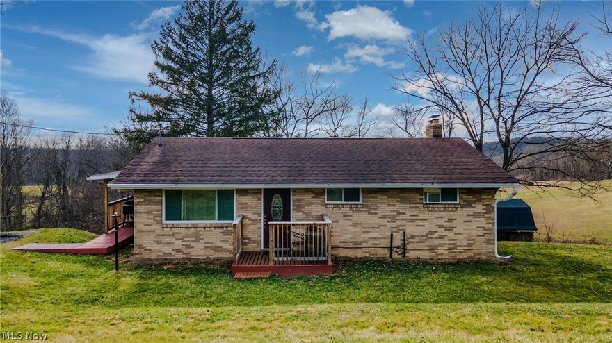 UNDER $200,000 WITH OVER AN ACRE *JUST* OUTSIDE OF THE GEM CITY CONVENIENCES!  Beautifully updated and move-in ready, this charming three-bedroom, two-bath home offers the perfect blend of modern comfort and classic character. Step inside to a bright and welcoming living space featuring stylish finishes and an inviting open layout that makes everyday living and entertaining effortless. The home also features a spacious eat-in kitchen, providing the perfect place for casual dining, morning coffee, or gathering with family and friends.  The upper level includes three spacious bedrooms, a full bath, and abundant natural light throughout, creating a warm and comfortable atmosphere. The fully finished lower level offers additional living space with a cozy fireplace, a second full bathroom, and a versatile bonus room that can easily serve as a home office, gym, guest room, or hobby space. Create some BBQ memories due in part to the covered deck, an ideal spot for relaxing or entertaining while overlooking the expansive, semi private backyard. Situated on over an acre,  the property offers plenty of room for outdoor activities, gardening, or simply enjoying the peaceful setting.  While the home provides privacy and space, it is also conveniently located close to city amenities, offering easy access to shopping, dining, schools, and everyday conveniences. This property truly combines comfort, space, and convenience in one beautiful package. Under 15 min from Major University , only one red-light between you and Pgh, PA, and be in WV or PA in less than 30 min!  Call today!