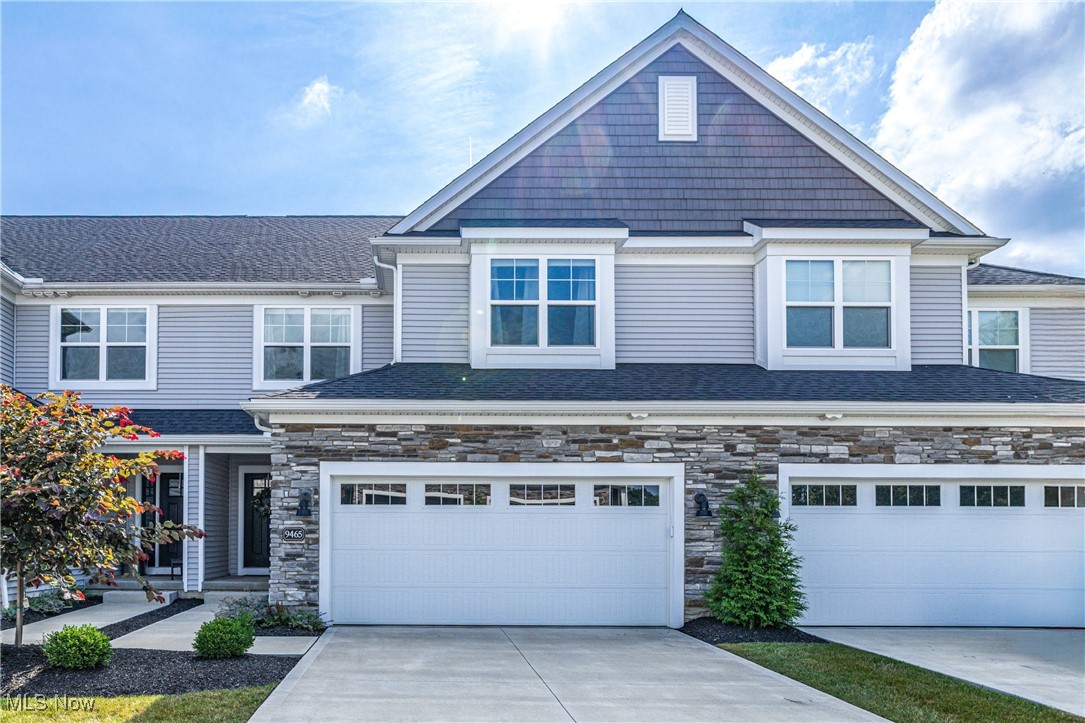 Welcome to 9465 Aquila Ct! Nestled in the heart of beautiful Broadview Heights, this nearly new townhome offers the perfect blend of style, comfort, and convenience. Tucked away at the back of the development, you’ll enjoy true maintenance-free living at its finest. The inviting curb appeal is highlighted by custom stonework, a contrasting shake peak, and vinyl siding. Step inside to a light-filled interior, where the two-story great room showcases a dramatic wall of windows. The modern, open-concept floor plan creates a seamless flow between the semi-professional kitchen, dining area, and the spacious great room anchored by a striking stone fireplace—perfect for both entertaining and everyday living. A convenient laundry room and half bath complete the main level. Upstairs, you’ll find three generously sized bedrooms, including the impressive owner’s suite with vaulted ceilings, a walk-in closet featuring custom built-ins, and a private en-suite bath. The lower-level rec room offers versatile space for a home gym, playroom, or media room, and is already roughed in for an additional bathroom if desired. Step outside to relax on your private patio, or take advantage of the unbeatable location just minutes from highway access, restaurants, and the award-winning Brecksville-Broadview Heights Schools. This turnkey home truly has it all!
