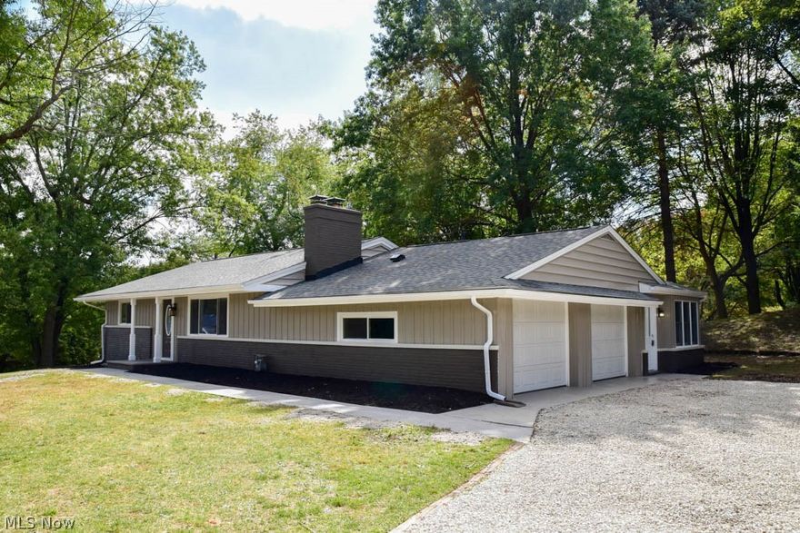 Completely remodeled 2-3 bedroom ranch on over an acre corner lot! Home has already been inspected for buyer's peace of mind! New flooring and fresh paint throughout! Beautiful bamboo wood flooring throughout most of the main level. The breathtaking great room offers cathedral ceilings and a beautiful brick hearth with a wood burner. The updated kitchen has stainless steel appliances, tile backsplash, new cabinets, granite countertops, breakfast bar and dinette. Welcoming living room with a woodburning fireplace and a picture window. Gorgeous, remodeled full bath with a new vanity, granite countertops, new tub and tile surround on the main level. The finished lower level adds 585 square feet of living space and includes a huge rec room, a possible 3rd bedroom and a beautiful, updated full bath with built-ins, tile flooring and shower surround. 2-car attached garage, too. With over an acre and the house situated in the middle, you have a deep, private front yard lined with trees and a s