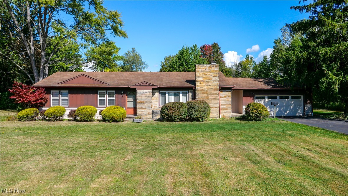 Opportunity knocks!! This charming 3-bedroom, 1-bath ranch offers over 1,400 sq. ft. of first floor living space, a full basement, and a 2+ car attached garage—all nestled on 5 beautiful acres in the heart of Aurora. Surrounded by nature yet close to shopping, dining, and top-ranked Aurora schools, this property delivers the perfect blend of rural living with city convenience. Enjoy the spacious living room with cozy fireplace, formal dining room, eat-in kitchen with a stunning view, first floor bedrooms with original hardwood floors and a full bath – the perfect layout for convenient one-floor living! The paved driveway with additional parking makes hosting events easy. Lovingly owned by the same family since it was built, this home is ready for your vision. Its generous layout, full basement, solid bones, and sought-after acreage/location provide the perfect starting point. The possibilities are endless! Bring your flair and transform this ranch into your forever “home sweet home.” Updates over the years – cooktop, roof, windows, waterproofing with transferrable warranty, attic insulation, HVAC. Don’t miss your chance to enjoy tranquil living paired with modern amenities in one of the area’s most desirable communities! Schedule your appointment today!