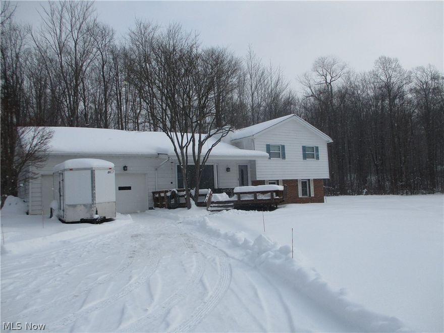 View this approximate 4 acre well maintained split with pond in front and treed backyard. A bay window and wood-burning fireplace accent the living room.   The kitchen features beautiful kitchen cupboards and an island with sink and eating area.  All appliances stay.  Home has replacement windows. The septic is approximately 3 years old.  The second full bath is not finished.  Furnace needs replacement. The lower level was partially waterproofed.  This property is priced to sell "as is".