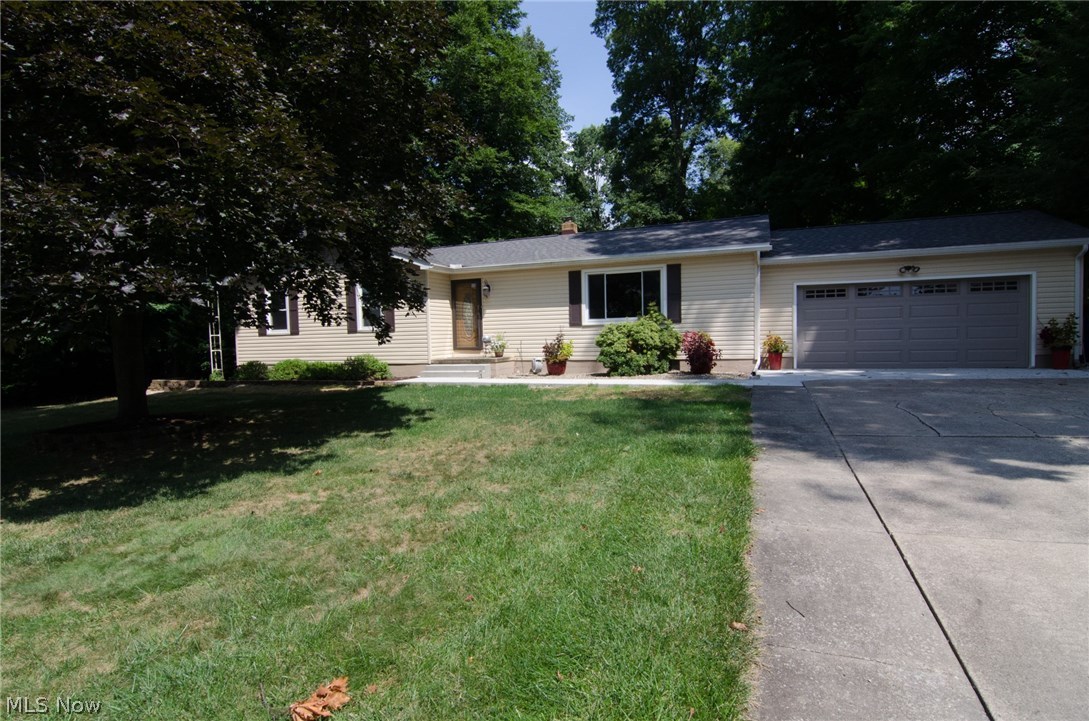 Beautifully updated Ravenna Township Ranch with finished walk out basement! Private wooded lot on a very quite street. This home has been meticulously cared for and offers tons of updates. All new kitchen in 2013, with custom maple cabinets, solid surface counter tops, glass & tile backsplash, undermount sink, stainless/black appliances, ceramic tile floor and pendant lighting. Peninsula seats 2/3 stools plus the dining area. The kitchen opens right into the living room. The living room area is currently split into a living/formal dining room, but could of course be use as a large living room. On the main floor there is the master bedroom and bath, as well as 2 additional bedrooms and a full bathroom. Main bathroom is all new in 2013 including marble flooring and cherry vanity. The master bath was remodeled in 2010 with tile flooring, granite topped vanity and custom tile work in the shower. On the lower level you will find the large 4th bedroom right at the bottom of the sta