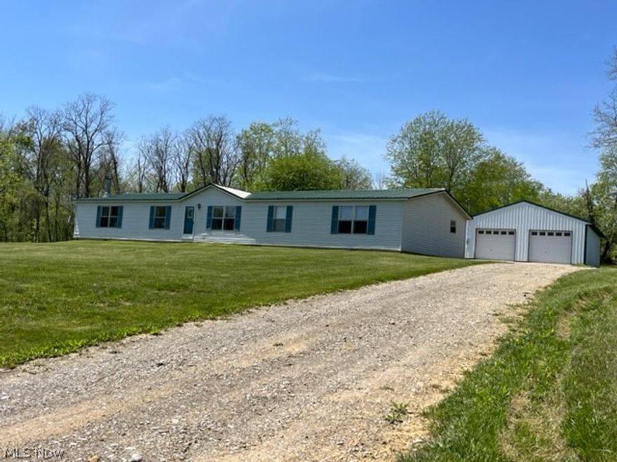 Pure Country Delight, setts back from the road, lovely four bedroom, 2.5 bath home ready to move into! Well-kept manufactured Ranch home on 5.99 Acres! Home features open floor plan with nice kitchen and dinging room opening to level backyard with deck and patio for great outdoor enjoyment! Large living room with wood burning fireplace, spacious fully applianced kitchen with island, office and family room, plus first floor laundry! Huge Master Suite with walk-in closet, and master bath with separate shower and garden tub for relaxing! Great for your family! Detached Pole building 40x30, 10ft ceiling, 3 garage doors, concrete floors, with wood burner, 200 amp electric in garage. Private well and septic,