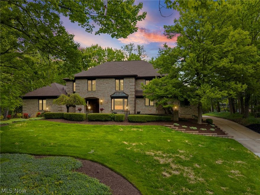 Welcome to this elegant brick French-style home perfectly positioned on a majestic hilltop setting offering timeless architecture, exceptional quality, and luxurious living throughout. Showing like new, this stunning residence blends sophisticated design with warm inviting spaces ideal for both everyday living and entertaining.

The dramatic two-story Great Room showcases a soaring stone fireplace and private entertaining bar perfect for morning coffee or evening gatherings, all flowing seamlessly to the open loft above creating an additional relaxing retreat. The beautifully updated kitchen features granite countertops, redesigned butler’s pantry, and exceptional functionality for hosting family and guests alike.

The luxurious first-floor owner’s suite is a private sanctuary complete with fireplace, vaulted wood ceiling, cedar walk-in closet, and spa-inspired bath featuring a jetted tub, double sinks, skylight, granite counters, and chic designer tile finishes. Sliding doors open directly to the spacious deck overlooking the breathtaking park-like grounds.

Outside, enjoy a professionally landscaped backyard with custom gazebo, welcoming trellis, paver patio, and winding private paths creating a peaceful retreat setting. A richly paneled first-floor office offers flexibility for a home office or additional bedroom.

Upstairs features an open loft, two spacious bedrooms with generous closets, newer carpeting, and an upscale full bath. The expansive lower level offers endless possibilities for recreation, fitness, playroom space, or abundant storage.

Additional updates include newer dual HVAC systems, upscale tankless hot water heater, and newer roof for added peace of mind. Enjoy neighborhood amenities including a private pool while being only minutes from Metroparks, shopping, dining, the Turnpike, and major freeways.