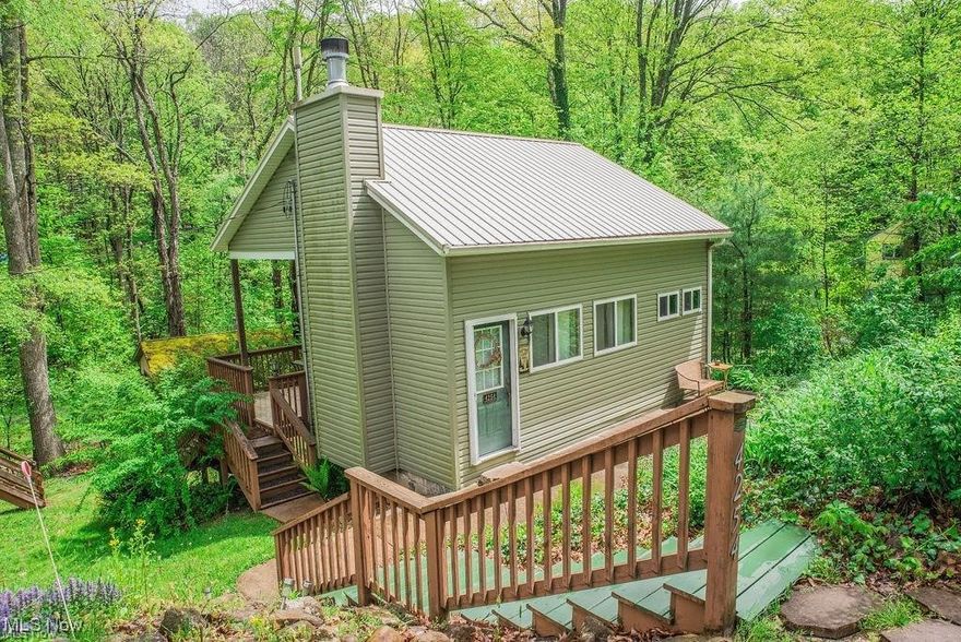 Lake Life Awaits!
Looking for the perfect weekend getaway or a peaceful year-round retreat? Look no further! This beautiful Amish-built cabin is just steps from Leesville Lake and offers the ideal blend of rustic charm and modern comfort.
Situated on a double lot, this property features a covered back porch accessible through sliding glass doors—perfect for relaxing or entertaining outdoors. Inside the main cabin, you’ll find 2 bedrooms and an adorable kitchen with all appliances to stay along with radiant floor heat in the living room, bedroom, and bathroom for cozy comfort.
A stunning wood-burning stone fireplace with a blower serves as the centerpiece of the living space. Additional highlights include a separate bunk house with bunk beds for additional guests, making this a truly move-in-ready lake retreat.
Whether you’re boating, relaxing, or entertaining, this charming lake property is ready for you to enjoy. Don’t miss your chance to own your own slice of lake life! Boat Dock space included, 1994 Crest pontoon available for purchase. No Airbnb permitted. Hensel Landing dues $150.00 a year. MWCD boat decals $283.00 per year. Kayak storage also available for a fee. The home has a composting toilet, Approved and inspected by Caroll County.