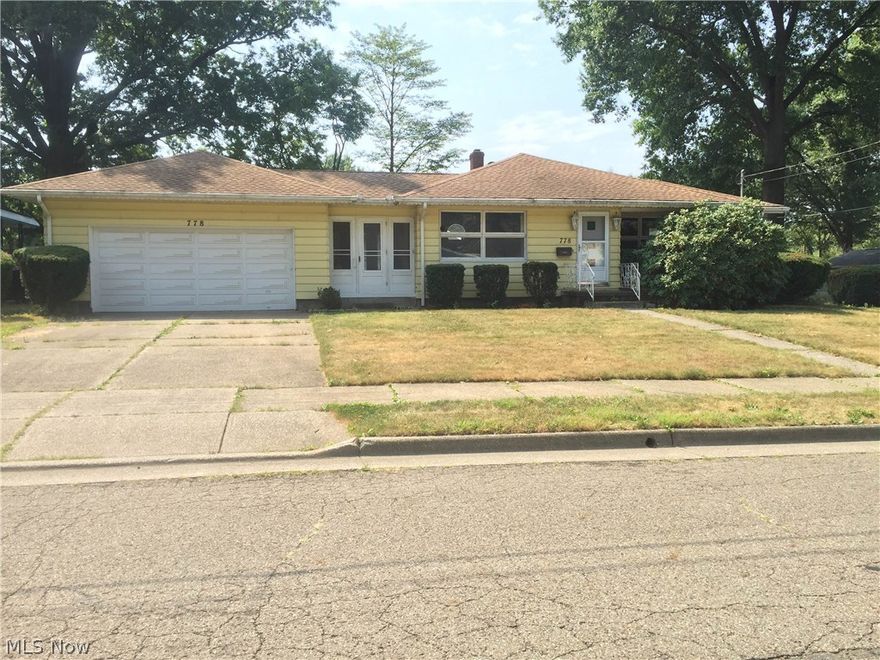 Sprawling 4 bedroom, 2 bath ranch with two 2-car garages - one attached and one detached.  Waterproofed basement in 2010, new roof in 2008, Finished basement with knotty pine paneling and tile floor.  Dining room has built in china closet.  Lots of storage, laundry hook-ups on both main and lower levels.  New storm doors, and outside of home is powerwashed and freshly painted (September 2015).  This home is situated on 3 city lots.