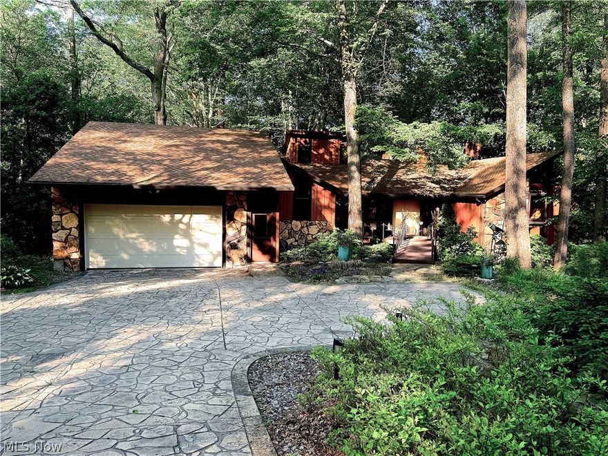 You can have it all with this custom built 4 BR, 3.5 Bath contemporary home! Enjoy the tranquility of nature while only 5 minutes from the freeway and 8 minutes from the Montrose area!  The previous owner was a master carpenter and built this home from the ground up with several unique features!  It is truly a one of a kind!  The living room has a massive stone fireplace and a sunken area to enhance the space.  The 1st floor master bedroom has vaulted ceilings, a stone fireplace, walk in closet, slider to an unbelievable view of the wooded backyard and a spiral staircase to a large wall of built in bookcases.  Bedroom 2 also has a spiral staircase with a loft area.  The kitchen, with solid surface countertops, center island and appliances combined with the dining area, are perfect for family gatherings with access to the grill area, outdoor dining and wrap around deck!  The lower level has a full workshop and tools (negotiable), a bedroom, full bath and media room with a walkout to a huge fire pit and hot tub!  This property also comes with access rights to Bluebird Lake!  This is like having your own personal retreat and is priced to sell!!