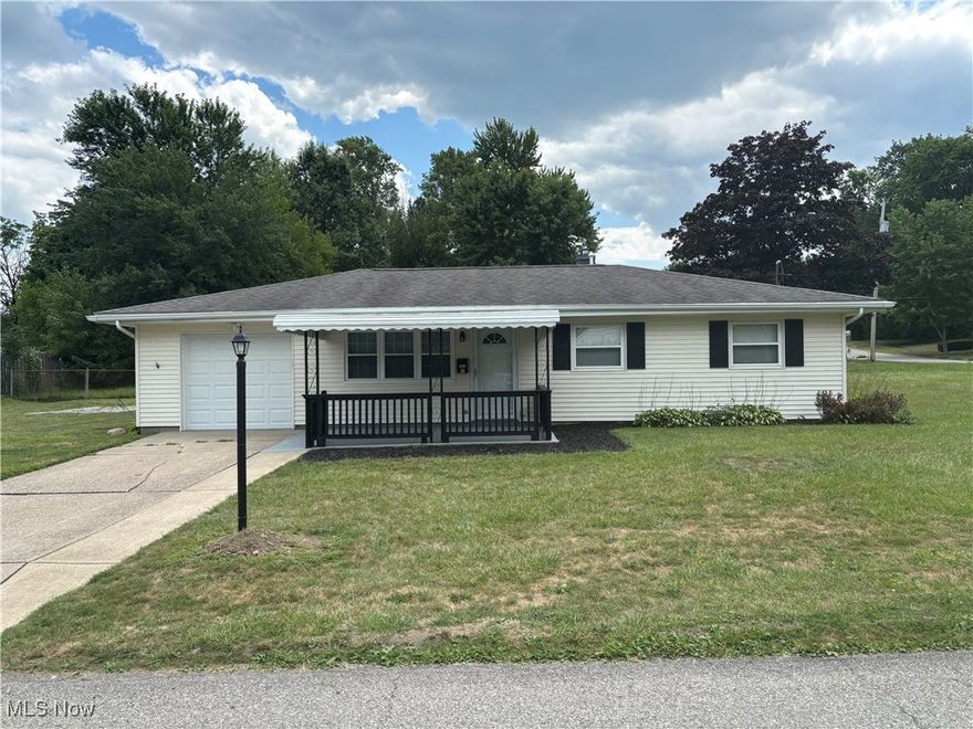 Welcome home, to this beautifully updated ranch home in the highly sought after Austintown School District. This 3 bedroom, 1 bath home has been completely updated. New interior and exterior doors, vinyl flooring, lighting, paint, and trim featuring a silver grey and bright white color palette. The open concept kitchen features new cabinets, countertop, subway tile backsplash and Samsung appliances. (french door refrigerator, glass top stove, microwave and dishwasher) all are  stainless steel. This updated kitchen opens directly into the dining room, creating a space large enough for entertaining. The property features an attached one car garage that has been freshly painted, and a patio in the back of the home that is surrounded by privacy fencing. The freshly painted, covered front porch is a great place to sit and enjoy the neighborhood, This house sits on a corner lot giving you lots of space for the kids to play! Newer roof, furnace and air (2019), HWH (2024). vinyl tilt in windows make for easy cleaning. Call for your private showing today. Motivated seller, bring your offer.