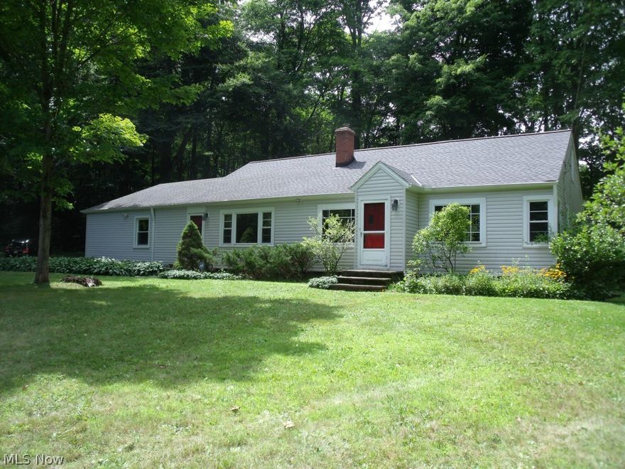 This secluded ranch style home is nestled within 11.5 acres in the heart of Kirtland, Ohio.  This breathtaking wooded property offers a creek, private pond, Amish built barn and an outdoor fireplace for family enjoyment.   Pride of ownership abounds with gas heating, newer vinyl siding, windows, and a newer roof with gutter guards.  Enjoy the comforts of a cozy stone hearth wood burning fireplace with large picture windows located in all the main rooms.  The spacious family room showcases custom cherry wood bookcases built from trees furnished from this very lot.   This home is located in close proximity to Holden Arboretum and the Lake Metro Parks for ease of hiking and other outdoor activities while just a short distance to freeway access.  This ranch has a finished dormer large enough to host a teenager or two.  A two car attached garage makes winters a breeze.  Come see what there is to love about this park-like setting!    ***** SELLER IS PROVIDING AMERICA'S PREFERRED HOME WARRANT