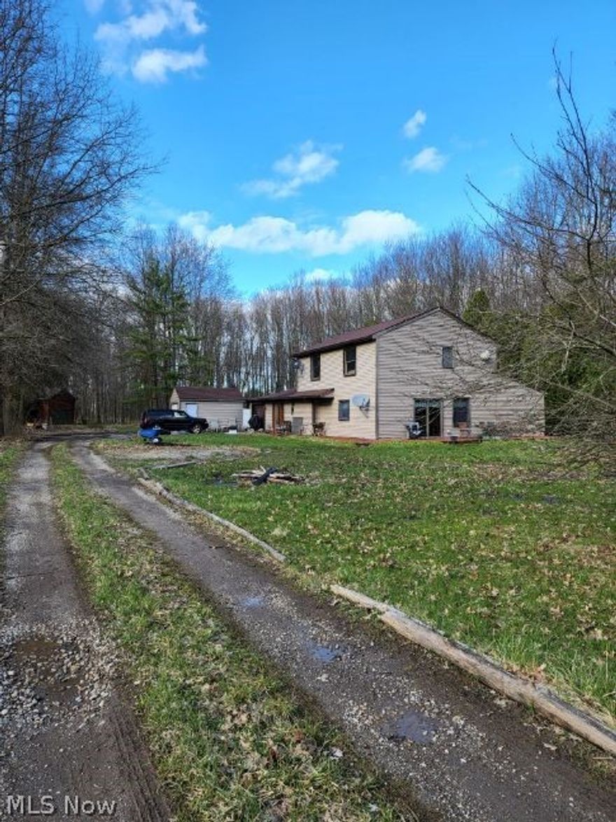 Spacious Contemporary Colonial in Olmsted Twp with 4 bedrooms, 1.5 bath, many extras and 2.9 secluded acres. Deck, 2 out buildings and an attatched garage. Kitchen has an oversized island and is updated with nice cabinets. First floor bedroom could be used as an office. First floor laundry room. Cozy, pretty and large. One of a kind property. A Must SEE!!! Home has a 1 year home warranty.