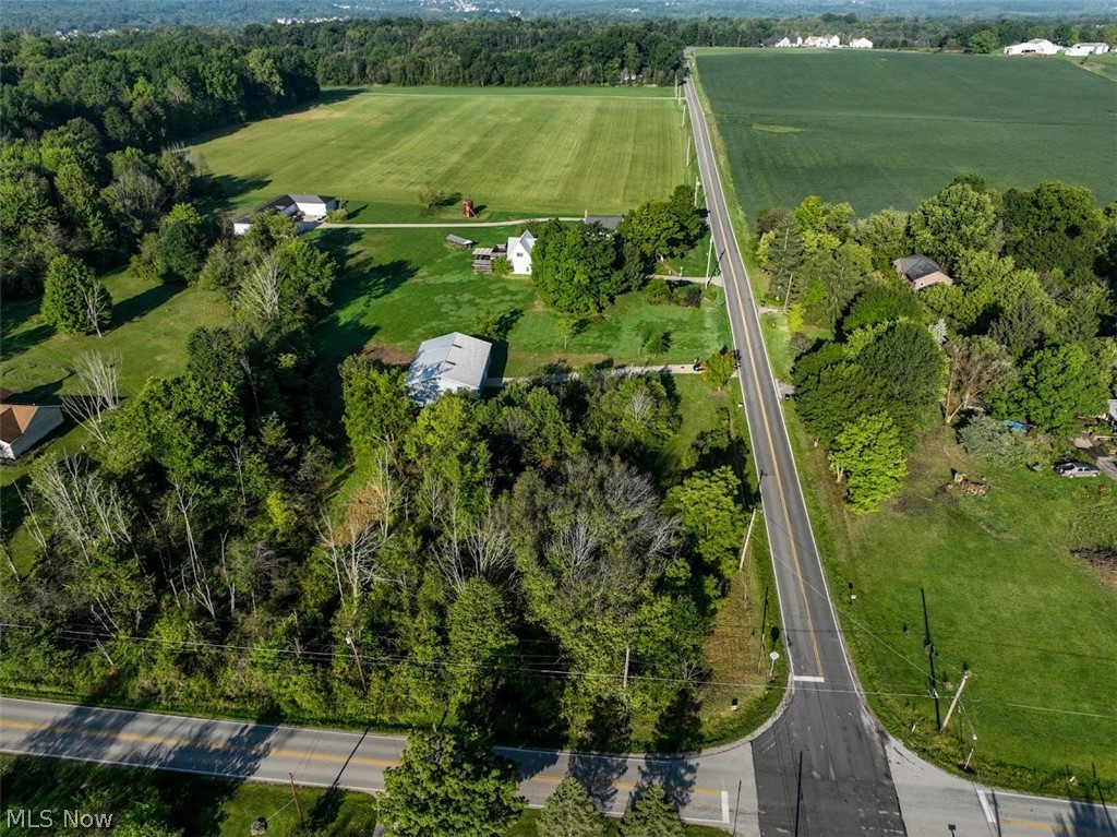 They aren't making any more land AND definitely not that you can have an amazing building only on. Rare find in a fantastic rural location, beautiful Sharon Township. This level buildable lot features 2.21 acres in the Highland School District. Large 2470 sq. ft. pole barn (60 x 42) with cement floor, skylights, man door, and 12ft high garage door offers massive storage for all of your recreational vehicles, equipment, cars and/or collections. Also, perfect for sports practice with ceiling trusses over 15ft. high. Inside electric updated in 2022 with electric box, hanging lights and outlets. Outside there's a new gravel driveway (150 x 12) and new gutters and downspouts 2022. Hazardous trees were removed and much debris cleared. Rain barrel with spigot for hose purchased and will be left for new owners with area for install cleared. Rural surroundings. Make it yours today!