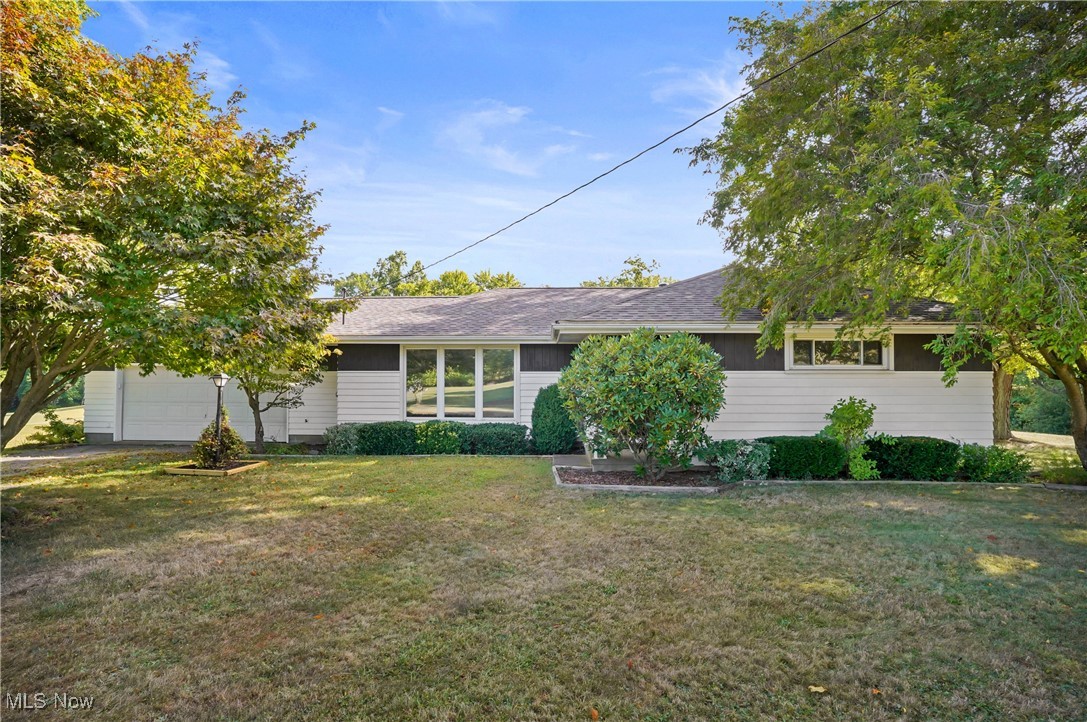 Charming 3 bedroom RANCH home on nearly 5 acres. Pride of ownership shines in the one-owner, well-maintained home tucked away and up a winding driveway and located on a quiet country road with very little traffic. The home showcases original hardwood floors throughout the living area and all 3 bedrooms. The home offers a large living room with picture window and is open to dining room. The kitchen is nice size with plenty of room for a breakfast table, 3 bedrooms and bath all on one floor. Step outside to a spacious deck overlooking the rolling, peaceful acreage-the perfect spot to unwind or entertain. Practical updates provide peace of mind, including a new central air system 2024, New Roof 2018, HWT 2023. An attached 2 car garage adds convenience. The full basement has plenty of storage. There is a large shed to house your mower. This property delivers the tranquility of rural living while keeping you an easy drive to Salem, Leetonia, Columbiana and Lisbon and easy access to Route 11 as well. Very centrally located in Columbiana County. Take a drive out to the Country for your private showing...you wont be disappointed