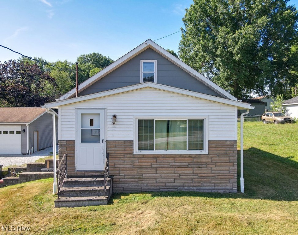 Discover the potential at 2330 Eastwood Avenue! Tucked away on a nearly 1-acre lot, this property offers rare privacy with the convenience of being just minutes from both Akron and Tallmadge amenities. Located near the city line, you'll love the easy access to shopping, dining, parks, and more all while enjoying the space and serenity of your own backyard retreat. The oversized 3-car garage is perfect for car enthusiasts, hobbyists, or extra storage, added bonus is the 1 car garage with an attached shed. Inside, this home is ready for your vision. Bring your personal touches and transform it into your dream home. Updates: Roof and HVAC 5yrs, Hot Water Tank 3yrs, Walls Insulated 2yrs. With location, land, and limitless potential, this one won't last!