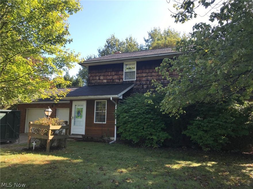 Here's your opportunity to get wooded acreage, a home, & 3 outbuildings at an affordable price!  The property is primarily wooded with 6.8 acres on 2 parcels. The home has a great floor plan and so much potential with some updating. There is a breezeway, cute kitchen with bayed dinette, formal dining room, living room, 3 bedrooms with loads of closet space, den, a full bath with 5' wide step in shower on the main floor, Master has a walk-in closet and access to the full bath on the second level, shower & commode in basement, full basement with walk-out and workshop, and 2-car attached garage.  There are also 2 outbuildings and a storage shed. Property sells "as is".  Convenient location just a short drive to I77 in Bolivar or SR800 in Mineral City.