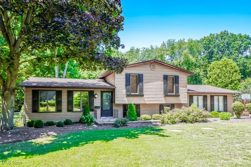 You'll find so much to love in this beautifully maintained Coventry split, from the spacious floor plan to the .63-acre lot with an in-ground pool! As you step inside, the gleaming hardwood floors catch your eye, flowing from the living room into the fully equipped kitchen and dining room. The bay window and brick accent wall add a cozy touch to the space. Upstairs, three generously sized bedrooms with large closets share a modern full bath with a jetted tub and shower surround.

The finished lower level is a true entertainer's dream, with a large family room featuring a beamed ceiling and wood-burning fireplace. You'll also find a bonus room that's currently used as an office, plus another full bath. Step outside into the vaulted sunroom and take in the view of the outdoor oasis complete with an in-ground pool, a beautifully landscaped yard, and mature trees. There's even a pool house for equipment storage, a shed, and a darling clubhouse for the kids.

Recent updates include a newer roof, spouting, vinyl fence, septic, hot water tank, and water softener. Homes like this don't come around often, so be sure to call today!