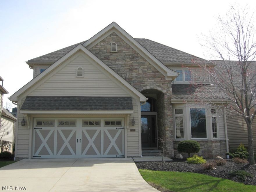 Showcase former model home in the River Creek of Acacia where quality of lifestyle is the priority. This detached cluster home is immaculate, turn key and in close proximity to east side's best shopping, main highways, University Circle and downtown areas. Numerous upgrades  includes: distinctive craftsman like quality of build, two story stone fireplace in the great room, gleaming hardwood floors from two story front entry to the first floor's expansive great room with outside deck and city views. All baths have customized tile floors and granite counter tops. Kitchen has Wolf Range, Ge Profile appliances and granite countertop. The lower level is light filled, street level finished w full tile floor bath and sliding glass doors to patio.Home boasts nearly 3800 living square feet of bright,open floor plan, addtl loft space and finished bonus space on flr 2, deck and outdoor patio. MBR w his and her walk-in closets by California Closets and entire home was professionally decorated. Out