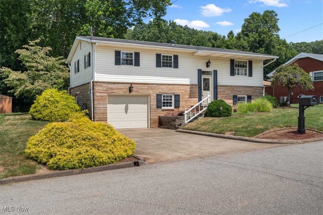 Come fall in love with this beautiful split entry with timeless curb appeal, nestled in a convenient location! Step inside to find hardwood floors and a functional layout, perfect for everyday living or entertaining. The oversized family room has vaulted ceilings, a beautiful fireplace and direct access to the private deck- perfect for morning coffee or unwinding of an evening. The main level features 3 bedrooms, 1.5 baths, living room, breakfast nook, kitchen and family room. Downstairs you'll be amazed by the natural light in the rec room, storage space and another full bath. The oversized 1-stall garage walks out to the wonderful and level backyard. This property is ready for immediate occupancy, and awaiting your personal touch!