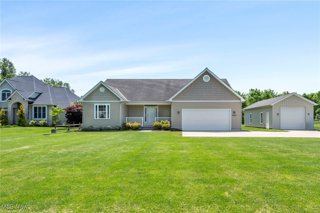 This spacious and well-maintained 3 Bedroom, 2 Full Bath ranch on 2 parcels for a total of 1.62 acres that blends modern convenience with peaceful outdoor living. The kitchen features dark flooring, ample cabinetry, and a central island that houses the sink and dishwasher. The island also includes additional storage and an extended counter perfect for casual dining. The dining area, located just off the kitchen, includes sliding glass doors that open to a small deck. The large living room is carpeted and offers high ceilings. The wood flooring and electric blinds add a touch of modern luxury throughout the home. All three bedrooms featuring carpeting, and neutral paint complements any style of décor. The full basement offers a blank canvas—ready for you to design the ultimate rec room, home gym, or additional living space. The long driveway leads to the attached tandem-3 car garage with race track flooring and a 22 x 44 detached pole barn, plus an additional garage with a covered area at the rear. The backyard also boasts split rail fencing and a 144 X 72 fully stocked 8-foot-deep pond providing a peaceful retreat right at home. A large covered back porch and a smaller deck off the kitchen add even more outdoor living space.