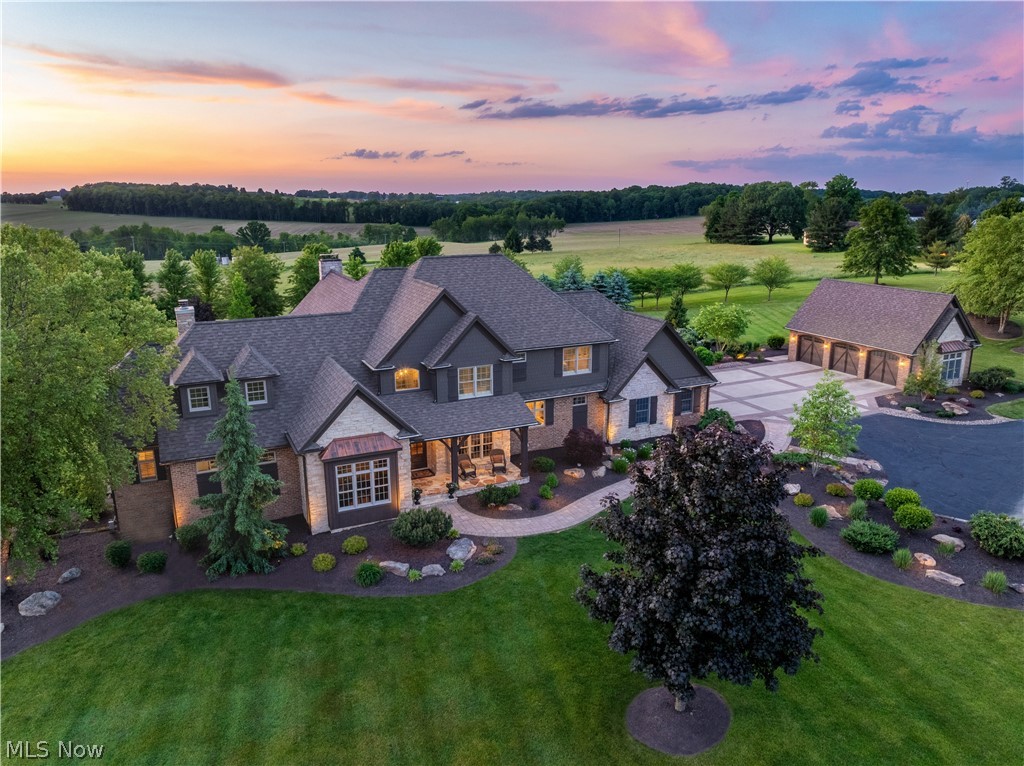Welcome to an extraordinary estate offering over 8,000 square feet of luxurious living space, set on 19.5 acres of picturesque landscape. This magnificent property boasts a walk-out lower level, a large saltwater pool, a 6-car garage, a stunning stable/entertainment area, and a beautifully maintained, fully stocked pond. This property is perfect for equestrians, featuring a beautiful 2-stall horse stable with a wash rack, a paddock, and 10 acres of pasture, along with a feed/tack room. The expansive first-floor primary suite is a sanctuary of comfort, featuring a cozy fireplace, dual vanities, a soaking tub, a shower, and another fireplace in the primary bath. The heart of the home is the stunning kitchen, designed for both everyday living and grand entertaining. It seamlessly flows into a spacious great room with a striking stone fireplace. For formal gatherings, the elegant dining room provides an open and inviting atmosphere. The first floor also includes a beautiful office, offering serene views of the meticulously maintained, fully stocked pond. Upstairs, you will find three generously sized bedrooms, each with its own bath and walk-in closet, as well as a versatile living/media room. The walk-out lower level is an entertainer's dream, featuring a large family room with a stone fireplace, an exercise room, a bar, and a game area. Step outside to enjoy the meticulously landscaped grounds, complete with a heated saltwater pool, perfect for relaxation and entertainment. The stable is ideal for horse enthusiasts or can be transformed into an additional living or entertainment space. This property combines elegance, functionality, and natural beauty, with over $1 million in upgrades throughout. Easy access to expressways and shopping, yet secluded for your privacy. There is so much to mention, we have a feature sheet for you. Don't miss the opportunity to experience this extraordinary estate.
