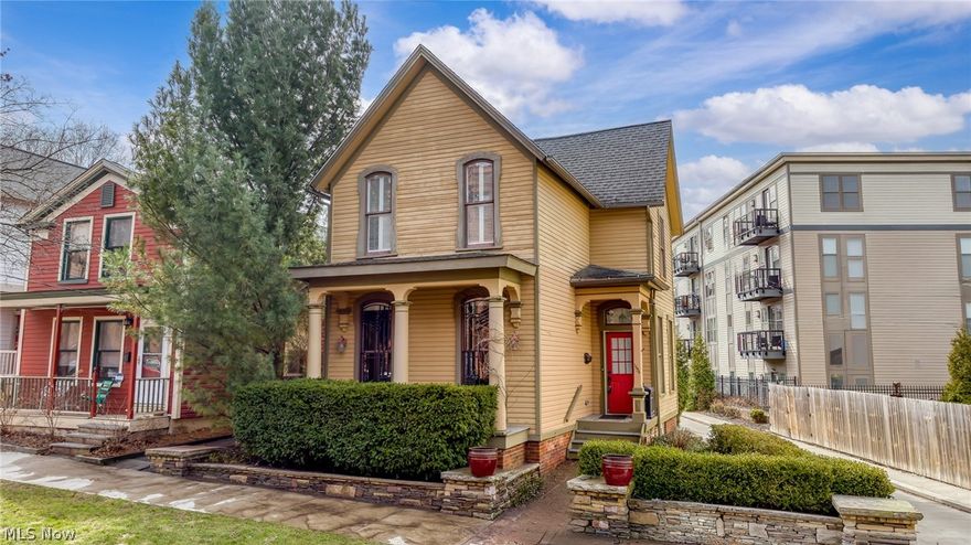 Tucked just one block from the vibrant heart of Hingetown in Ohio City, this exceptional residence delivers the rare blend of historic character and modern design that today’s buyers crave. From the moment you enter, the home feels both airy and grounded. It has soaring ceilings, oversized windows, wide-plank flooring, original trim/doors/woodwork that all culminate to preserve its timeless soul.  The main living space flows effortlessly, anchored by a striking vaulted kitchen with skylight, center island and seamless connection to the dining area - making it ideal for everyday living and entertaining. A charming parlor with decorative fireplace offers flexibility as a cozy lounge or bedroom (current owners used as their first floor primary bedroom!). A spacious full bathroom with clawfoot tub/shower completes the first floor. Upstairs, the vaulted primary suite feels like a private retreat, complete with a lofted bonus space and a beautifully appointed bath featuring a double vanity, walk-in shower, whirlpool tub, closet and upstairs laundry. Another upstairs bedroom charms with its built ins. Every detail strikes a thoughtful balance between comfort and style. Outdoor living shines just as brightly. Enjoy a professionally landscaped, private patio surrounded by elegant stonework, plus a rare rooftop deck perched above the two-car garage. It is the perfect place for unwinding or hosting under the city skyline. A full basement offers ample storage options. All of this in an unbeatable location just a HALF block from neighborhood favorites, coffee shops, and dining, with easy access to downtown, Tremont and Gordon Square Arts District. Enjoy nearby trails like the Lakefront Bikeway to Edgewater Park and the Red Line Greenway. With 2027's Irishtown Bend completion, the city's newest and most impressive park and views will also just be one block away. This home lives as beautifully as it looks and allows for city living at its finest.