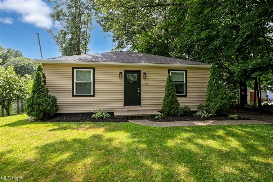 Lake Front Here We Come!!!  You don't need a half million dollars or more for a gorgeous lake home.  Welcome to 678 Portage Lakes Dr!  An absolutely STUNNING home sitting on the southeast side of the North Reservoir.  A 1 minute drive to PIX and just 4 minutes to Turkeyfoot Golf Course and the Upper Deck!  This lake cottage has been 100% remodeled!  All new Siding, Windows, Gutters & Gutter Guards, Soffit, Facia, Garage Roof, Exterior doors, A/C, Electrical box, Water Heater, Holding Tank and Entire Interior!  Step inside and be WOWED!  Wide open floor plan with an immense amount of natural light.  LVT flooring runs though the home along with recessed and access lighting.  Two crisp and efficient bedrooms, lovely full bathroom and great storage.  But let's talk about the focal point of the home, the SHOW STOPPING Kitchen!  Unique custom cabinets, stainless appliances, floating shelves, quartz counter top, oversized quartz island with seating and the most perfect view through the pictur