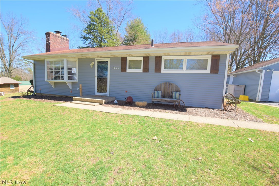 Three bedroom, 1.5 bath home located on a quiet street in the City of Green. The spacious living room has beautiful hardwood floors, a brick fireplace, and a bay window overlooking the front yard. The kitchen has new flooring, gray cabinets, and a newer sink/counter tops. The two kitchen windows allow nice natural light. Off the kitchen, there's a door leading to the back covered cement patio that overlooks the large, open backyard lined with trees. The three bedrooms have hardwood floors and neutral paint. The bathroom has a lot of counter and storage space. The basement is partially finished with a half bath and bonus rooms that could be used for a family room, craft room, or rec room -- the options are endless! Detached two-car garage. The yard is about 3/4 acre creating plenty of room for enjoying the outdoors. Lots of updates! Kitchen 2018, remodeled bedroom 2016, storm doors 2016, exterior painting 2016, and full exterior electric to outdoor building updated in 2018! This home wo