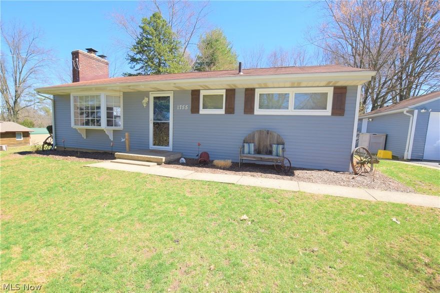 Three bedroom, 1.5 bath home located on a quiet street in the City of Green. The spacious living room has beautiful hardwood floors, a brick fireplace, and a bay window overlooking the front yard. The kitchen has new flooring, gray cabinets, and a newer sink/counter tops. The two kitchen windows allow nice natural light. Off the kitchen, there's a door leading to the back covered cement patio that overlooks the large, open backyard lined with trees. The three bedrooms have hardwood floors and neutral paint. The bathroom has a lot of counter and storage space. The basement is partially finished with a half bath and bonus rooms that could be used for a family room, craft room, or rec room -- the options are endless! Detached two-car garage. The yard is about 3/4 acre creating plenty of room for enjoying the outdoors. Lots of updates! Kitchen 2018, remodeled bedroom 2016, storm doors 2016, exterior painting 2016, and full exterior electric to outdoor building updated in 2018! This home wo