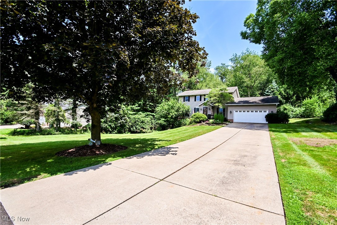 Welcome to 1236 Spring Valley Ave – a stunning 4-bedroom, 3.5-bath home nestled on a serene, nearly 1-acre wooded lot. This rare find offers the perfect blend of privacy and space, ideal for both everyday living and entertaining. The beautifully landscaped backyard is a true retreat, featuring two spacious decks, a charming brick fireplace, a screened-in gazebo, and a well-maintained storage shed for all your outdoor needs. Step inside to discover a thoughtfully designed main level with gleaming hardwood floors, a dedicated home office with custom built-ins, a convenient first-floor laundry room, and an updated kitchen equipped with modern stainless steel appliances. The open-concept layout effortlessly connects the kitchen, dining, and living areas, creating a warm and inviting atmosphere. Upstairs, you'll find four generously sized bedrooms and stylishly updated bathrooms, offering comfort and functionality for the whole family. The finished walkout basement adds even more living space, complete with luxury vinyl plank and new carpeting, a fully renovated full bath, a bar area, and a cozy fireplace—perfect for movie nights, game days, or hosting guests. This move-in-ready home checks every box. Don’t miss your opportunity to own this peaceful, picture-perfect property!