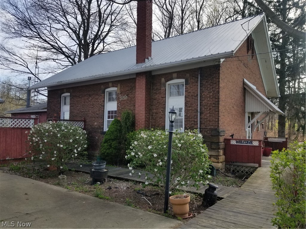 Great opportunity for the "handy" buyer to own this historic schoolhouse with gorgeous country views! The schoolhouse was converted to a 3BD/2BA home with a Family Addition & huge garage. The 1st floor features a kitchen with oak cabinets, Dining Room & Living Room with propane fireplace, family room with mini-split, full bath with shower stall & laundry area. 2nd floor has 3 BD's and a full bath. The second floor is in need of repair and finished. Newer vinyl windows throughout, metal roof, 1 car garage with huge workshop area, deck and private patio area. Selling "As-Is" to settle an estate. Looking for the right buyer that appreciates the charm & character of the home, loves the country and has a vision to restore the beauty of this home!