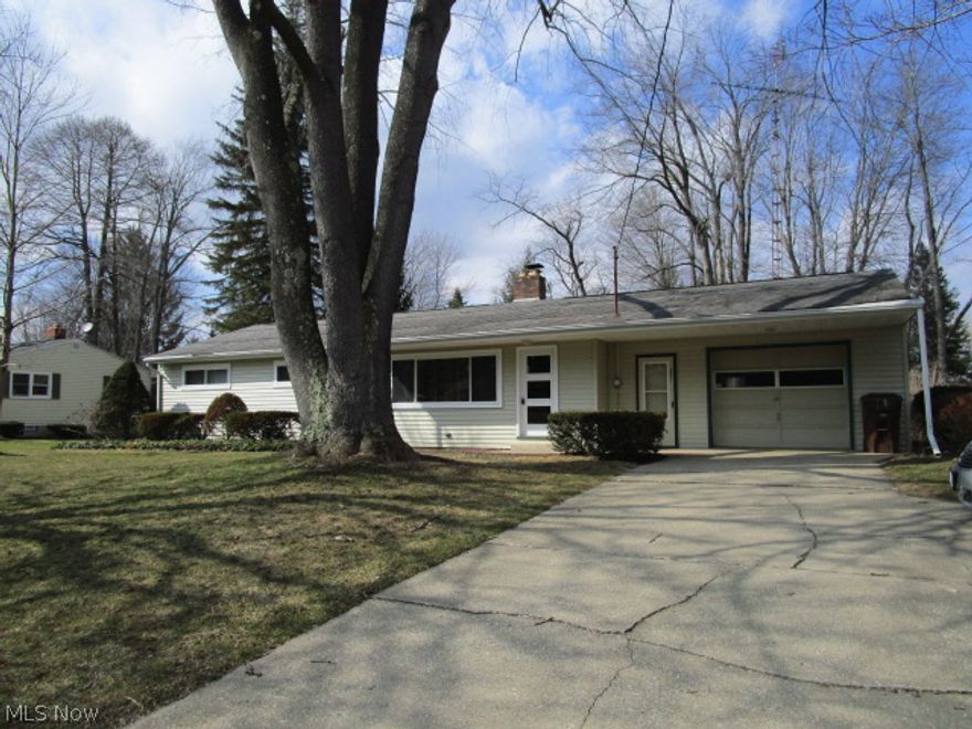 Sellers want this SOLD! They have completely refreshed this inviting ranch; 5 new windows in 2014 ($5000), state of the art water conditioner w/ reverse osmosis ($5000), new paint, updated baths, new LR carpet, refinished HW floors, faux finished counter tops & a Trane 90% furnace/ AC unit. Everything feels fresh & new! Attached garage w/ basement access is super handy-basement was waterproofed by former owner & is dry enough for the sellers' office & work bench area, & offers tons of storage space. There's a sunny formal dining room with an awesome built in nook; just perfect for your laptop, desktop or TV! The HUGE picture window offers amazing views of the big back yard, complete with a firepit, mature shade trees, a small sledding hill & a creek for hours of fun outside.Kitchen is compact & efficient, complete with dishwasher, counter top stove & built in oven. The large living room also features a brand new BIG picture window, for lots of light, & there's a WB FP for those chilly