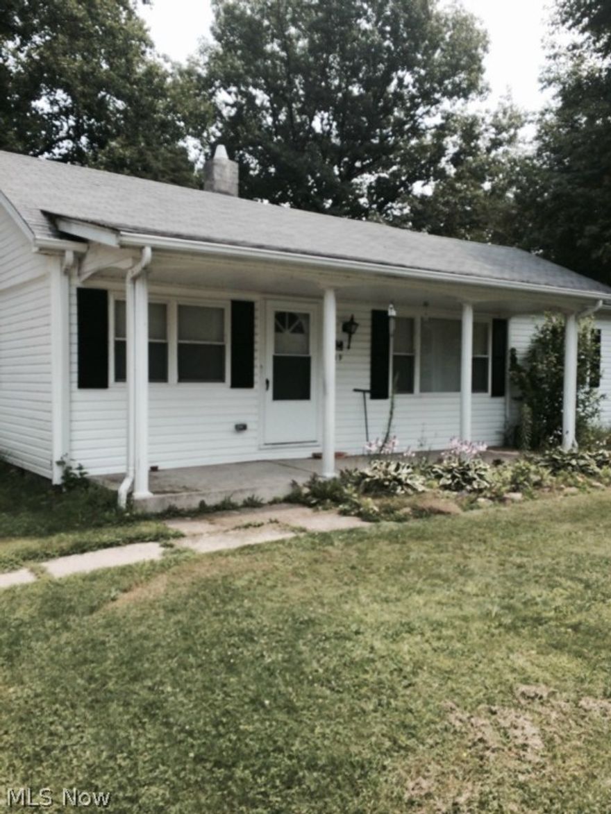 This ranch style home is situated on 3 lots. It contains 2 bedrooms and 1 bath. It also features a huge kitchen with newer oak cabinets and a large eating area. It also has a separate dining area and new carpet. There is a one car attached garage and a large out-building that could be used as an extra garage. This home is in move-in conditon.