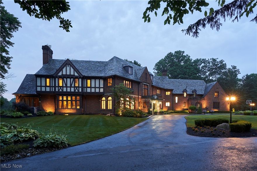 A Residence of Exceptional Grace & Grandeur, 47 S Wheaton is an Architectural Treasure—a Dignified 1930 English Tudor Manor, set on 2.4 pvt acres & spanning over 9k sq ft, this brick & stone Manor offers historic charm, modern functionality, & stately grounds. The home’s exterior evokes old-world elegance, with its hand-hewn stonework, layered tile roof, & huge steel-framed casement windows. A pvt circular drive is framed by mature trees & lush, manicured landscaping. The front door is in an arched cove leading to a large foyer w/arched doorframes. Step inside to discover interiors that have been lovingly maintained & thoughtfully updated. Original intricate millwork, ironwork details, lithographs & 10’ ceilings reflect the craftsmanship of a bygone era. Designed for both gracious entertaining & comfortable living, the floor plan offers expansive rooms, a large kitchen, library, solarium, & intimate family spaces. The 1st level provides 3 Dining/Banquet rooms & 2 screened porches. The Owners suite is inclusive of 2 bedrms & multiple custom closets, w/his & her dressing rooms. The 2nd floor has 2 add'l bedrooms w/ensuite baths providing privacy & convenience. The 2nd level also connects to an original Chauffeurs apt/suite w/full BA & the Maids quarters that were originally 2 bdrms w/a hall bath. There are breathtaking views from every window. The 3rd floor is finished as well & could be used as an expansive children’s playroom, office, hobby area etc. The basement is finished w/a family rm & gorgeous fireplace. This is the perfect movie theatre room w/projector. An elevator provides a lift to the upper floors if needed. There is also a built-in 3 car garage, w/plenty of space for parking & a circular drive. The grounds are full of old growth plantings & sweeping views from the stone terraces to the notable wading pool & English Gardens. This one-of-a-kind property is truly a rare offering—ideal for the discerning buyer seeking heritage, grandeur, space, & tranquility