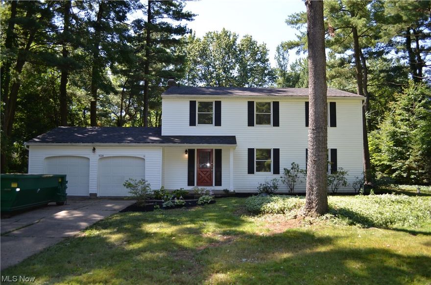 A beautiful Colonial surrounded by trees, in the heart of Hudson. Freshened up with new carpeting and paint. The first floor includes a living, dining and family room w/fireplace. A wood paneled bonus room has sliders that exit to a private deck, perfect for viewing the treed lot. A powder room is located off of the foyer. Also on the first floor is an office and eat-in kitchen w/views of the yard. Office has a spiral staircase that leads to the lower level, which includes an enormous wine cellar. The second floor has four nicely sized bedrooms with many closets and two full bathrooms. Owner's suite has a wall of closets and windows with a backyard view. The en suite bathroom makes this space your home. Located in the very desirable Hudson City School district.