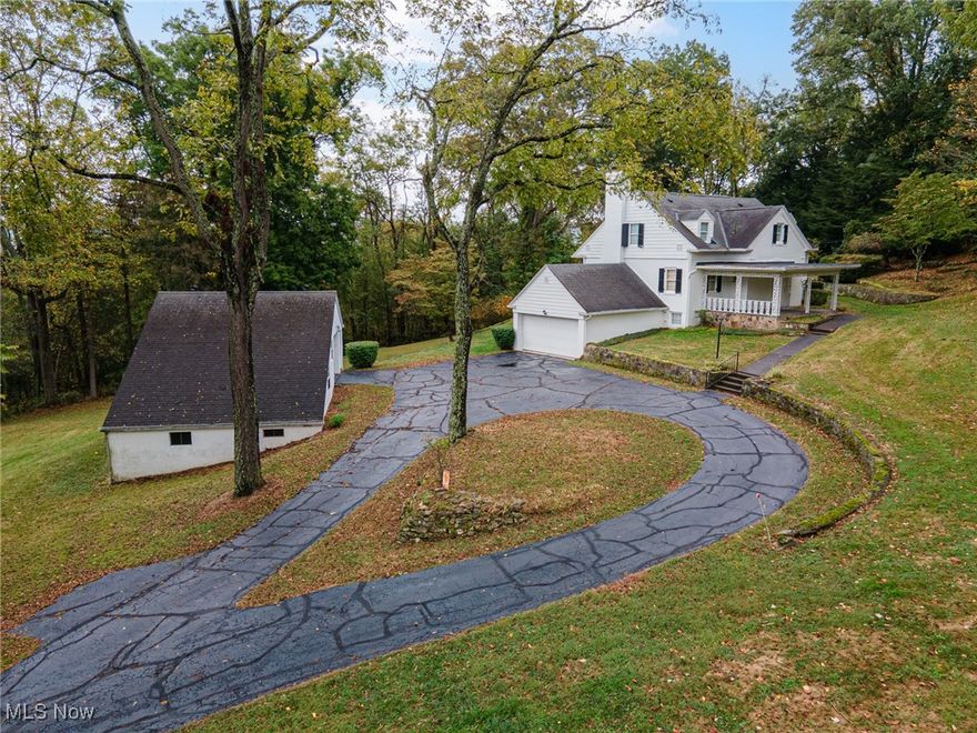 Tucked away among rolling pasture and timeless stone walls, this 13.49-acre mini farm feels you've stepped into the English countryside.  The beautifully landscaped grounds, and stately brick home set the stage for a property unlike any other.
The home itself is filled with character—three bedrooms, two full and one half baths, and beautiful woodwork and two fireplaces(plus a wood burning stove in the basement). The owners share that beneath the carpet on the first floor lies original hardwood, ready to shine once again. An attached garage adds convenience, while large windows frame views of the surrounding countryside.
Outside the bank barn and separate shed were once home to horses and llamas and it still stands ready for animals, storage, or hobby use, with two garage doors adding functionality. Nearby, the detached two-car garage offers even more possibilities, featuring a finished second floor that could serve as a studio, office, or creative retreat. This garage has its own water supply being spring-fed. Stone walls weave through the property, adding both charm and history, while the fenced pasture is ready for livestock, horses, or simply open space to enjoy. Every corner of this property invites you to slow down and take in the beauty of the land.
This mini farm isn’t just a property, it’s a lifestyle, where you can create the life you’ve been dreaming of.