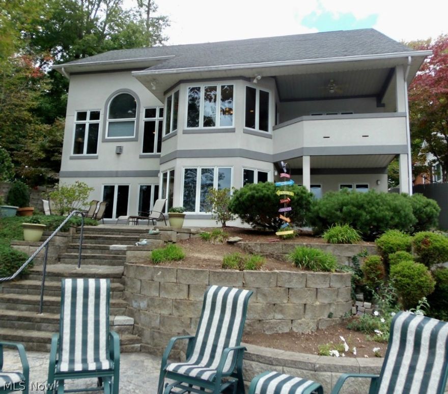 Beautiful Zaratsian custom built with 2 x 6 Arckansas Construction.  3 Bedroom 3 1/2 bath, 3 Kitchens, private Drive hold 15+ cars. Complete guest suite including kitchen, on lower level,cherry floors, marble & granite foyer, premium windows, surround stereo system, inside & out, prof. landscaped.  Silhouettes Hunter Douglas window coverings through-out. Complete guest/in-law suite with full  Kitchen in walk out finished lower level. And an additional full 3rd Gourmet Restaurant Style Kitchen out by Lakeside, with 3 sided Granite Counters,wet bar with water & ice,Kitchen Aid 46 inch Grill with Sear burner,2 burner outdoor stove,warming draw,flat screen T.V.Imported 16 foot Jumbrella w/lights (Hurricane proof) Lake and Golf views.Steel sea wall. Ask for info sheet to much to mention Here!