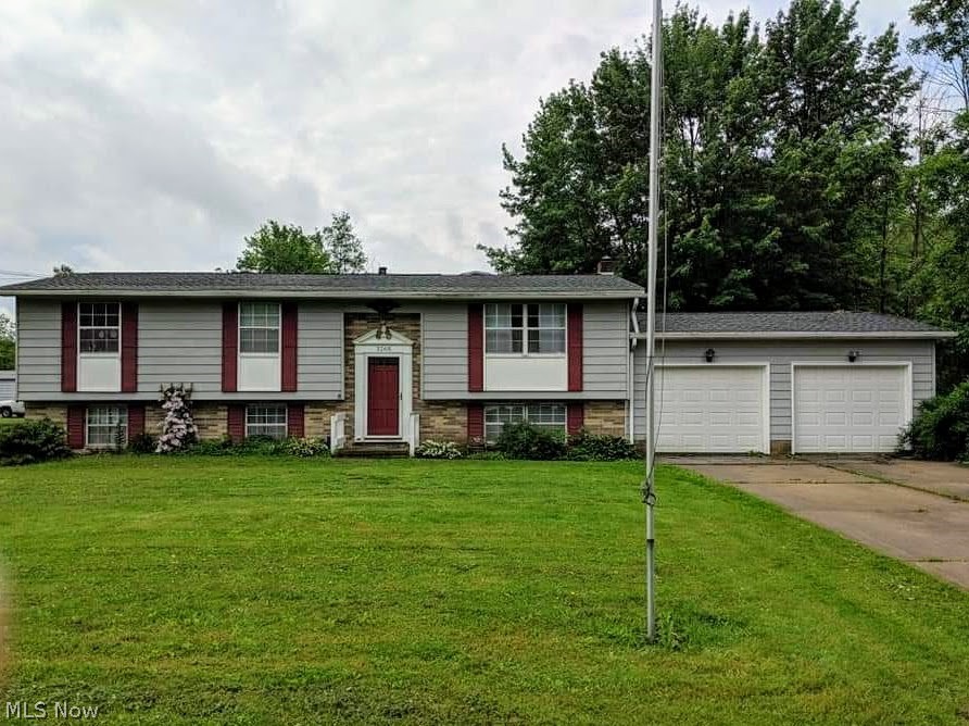 Welcome to this spacious 4 bedroom 2 1/2 bath Bilevel home nestled on 1.79 acres in Ravenna Township. This home features vaulted ceilings and laminate floors throughout the main level. The kitchen features Kraftmaid cabinets and newer appliances. Full bathroom in master bedroom. The large family room has a half bathroom and overlooks the private backyard which borders Breakneck Creek. The large walkout lower level includes a 4th bedroom, a rec room, and plenty of room for storage. Recent updates include newer roof, furnace, duct work, laminate floors in bedrooms, water softener, diaphragm pressure tank, 2 sump pumps, kitchen appliances, and paint. 2 car attached garage. Home needs a few finishing touches. Motivated seller. Home warranty included. Call today to schedule your private showing.