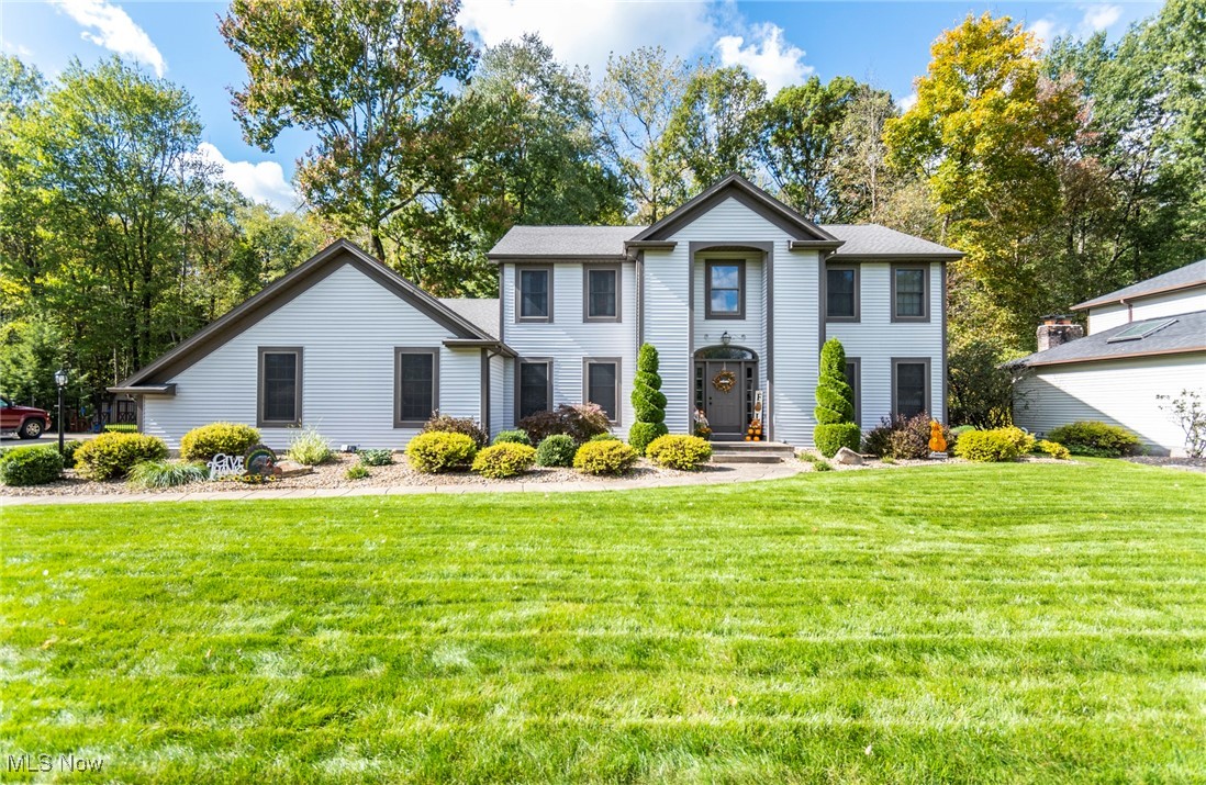 If you've been waiting for 'the one' -- you've found it! Tucked away in Mill Creek Estates, off of Parkside Dr. in Boardman, is this 5-bed, 3 full-bath home, offering 3,000+ sqft. of living space on a half acre lot. The back yard is abutting the wooded portion of the Mill Creek Park's south end, with hundreds of acres of park property behind. As you enter the 2-story foyer, you will notice natural light pouring in through the sidelite/transom windows, leading you to the first of 2 living areas, featuring newer carpeting. Across the hall is your formal dining room that opens up to the kitchen with island seating, a built-in desk area, an abundance of cabinetry, all new stainless appliances and a second dining area. Down the hall is your FIRST FLOOR laundry room, along with your first floor secondary bedroom and it's own full bathroom with walk-in shower. Moving to the back of the home, the four seasons room (perfect for a home office) features French doors, sky-lighting and double sliding glass door access to the recently finished deck, fully fenced back yard, and storage shed. The spacious family room opens up from the kitchen and is as cozy as can be, with warm rich tones of original woodwork and gas fireplace with beautifully tiled surround. Heading upstairs you have the master bedroom to the left, with vaulted ceilings, a walk-in closet and updated ensuite bathroom with walk-in shower and tile surround. Down the hall are three other secondary bedrooms along with a shared full bathroom. The open and dry basement is a blank canvas ready to be finished, and has an additional room separated off for storage. High efficiency furnace and sump pump new in 2022. A/C is 6 yrs. old with lines redone in 2024, Roof approx. 13 yrs. old., Hot water tank 2023. Call today and let's get you in your new home!