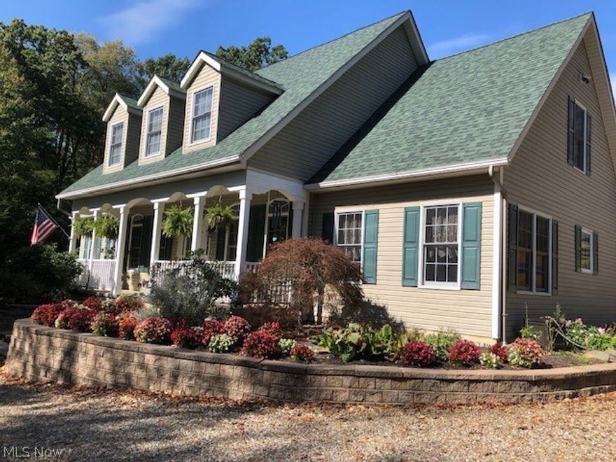 This spectacular home is paradise in the country!  Sundrenched rooms galore. Fireplaced great room leads to the concrete patio with view of enchanting waterfall and pond.Fully applianced eat-in kitchen with granite and Merillat maple cabinets. All low maintenance wood floors are Hickory wood and recently refinished. First floor master ensuite offers new carpet, granite countertops, new skylight and ceramic floors. The second full bath on the first level also offers granite countertops and ceramic flooring. Enjoy the morning sun on the enticing full front porch overlooking woods. When you visit the walkout lower level, you will notice poured concrete walls, workshop area, and lots of storage space as well as steps for private entrance from oversized 2 car, attached garage. The exterior of the home has teak flower beds with lots of perennials, oregano, thyme, sage, chamomile, and tarragon. Enjoy long walks in the acres of woods. The additional 30X40, two story garage with electric was bu
