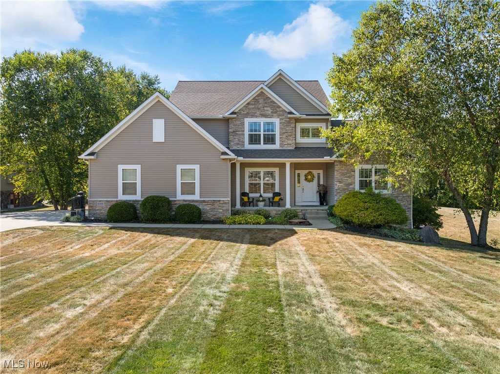 **Welcome to 6392 Caribou Dr.** This beautiful 4-bedroom, 3.5-bath home with a **first-floor primary suite** sits on a 1.13-acre lot in the desirable **Green School District**. Step into the **spacious foyer**, where soaring 19-foot ceilings in the family room set the tone for the home’s open design. A versatile **dining/tea room** with French doors, custom window treatments, and a stylish light fixture adds elegance. Most of the first floor is finished in **Anderson White Oak hardwoods in a modern gray color**. The family room showcases a wall of windows with custom shutters and drapery plus a **gas fireplace with refinished mantle**—perfect for gatherings or cozy evenings. The **remodeled kitchen (2020)** features light cabinetry, **quartz countertops**, marble backsplash, stainless steel double oven, dishwasher, and gas cooktop, plus updated faucets and modern lighting. The vaulted eat-in area opens to a two-tier deck for that takes you down to the lower walkout level stamped patio. Nearby, a mudroom connects to a large laundry room with potential for a scullery if desired. The **primary suite** offers vaulted ceilings, custom window treatments, his-and-hers walk-in closets, and a new fan/light fixture. The **updated ensuite** includes double sinks with Corian countertops, a walk-in shower with dimensional white tile, updated fixtures, and new flooring. A **stately curved staircase** leads to the second floor, where a generous landing overlooks the family room. This level also includes three bedrooms and a remodeled full bath. The walkout lower level nearly doubles the living space with three large finished areas, a custom **ventless gas fireplace with floor-to-ceiling hickory paneling**, and a full bath with tiled shower. A **basement utility garage** with double doors provides space for mowers, bikes, tools, or a workshop. With a spacious backyard, no HOA, and many updates, this home is move-in ready. Don’t miss your chance to call 6392 Caribou Dr. home!