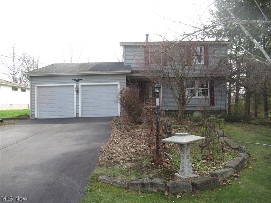 This 2 story 3-bedroom home has a great location!! Minutes from the bike trail!! Walk-in to the foyer area with a nice size coat closet and laminate floors.  To the right is a L shaped living room / formal dining room with a bay window and carpet floors.  Awesome Sunroom surrounded by 3 walls of each uniquely designed of custom windows and cathedral ceilings with skylights to enjoy sunshine from every angle. Nice size kitchen with appliances staying, garden window, and laminate floors.  Family room with carpet floors and sliding door leading a huge deck with multiple levels.  1/2 bath with laminate floors.  2nd level with master bedroom with two other bedrooms with carpet floors. Updated full bath with ceramic tile shower with bench seat, pedestal sink, and ceramic tile floors.  The basement offers great storage space, 40-gallon hot water tank, Luxaire forced air furnace with a/c, laundry area with washer and dryer to stay. 200-amp electrical box.  2 car garage. The landscaping is an outdoor enthusiast dream come true!!! 2 Sheds Austintown Schools.  Home warranty included!!! Call today for your private showing!!!!