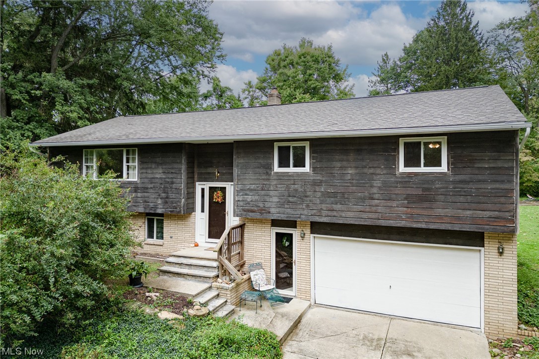 Rare opportunity for a lovely bi-level home on a fantastic 2.45 acre lot in Broadview Heights! This one-of-a-kind property features a lush wooded lot with the home setback from the street and a portion of the Chippewa creek that runs through the yard! Inside the home, there are 4 bedrooms, 2 full bathrooms, spacious living areas, and extensive updates throughout. The front door opens into the stairway with the living room just upstairs. Here you will find a large picture window and updated laminate flooring that flows throughout most of the upper floor. The living room is open to a lovely formal dining with sliding door access to the raised back deck. You will love the updated kitchen that includes a full complement of newer stainless steel appliances, newer countertops, and updated cabinets. Down the hallway are three sizable bedrooms with ample closet space. Two bedrooms features laminate flooring while the largest third bedroom features carpeting and private access to a tastefully u